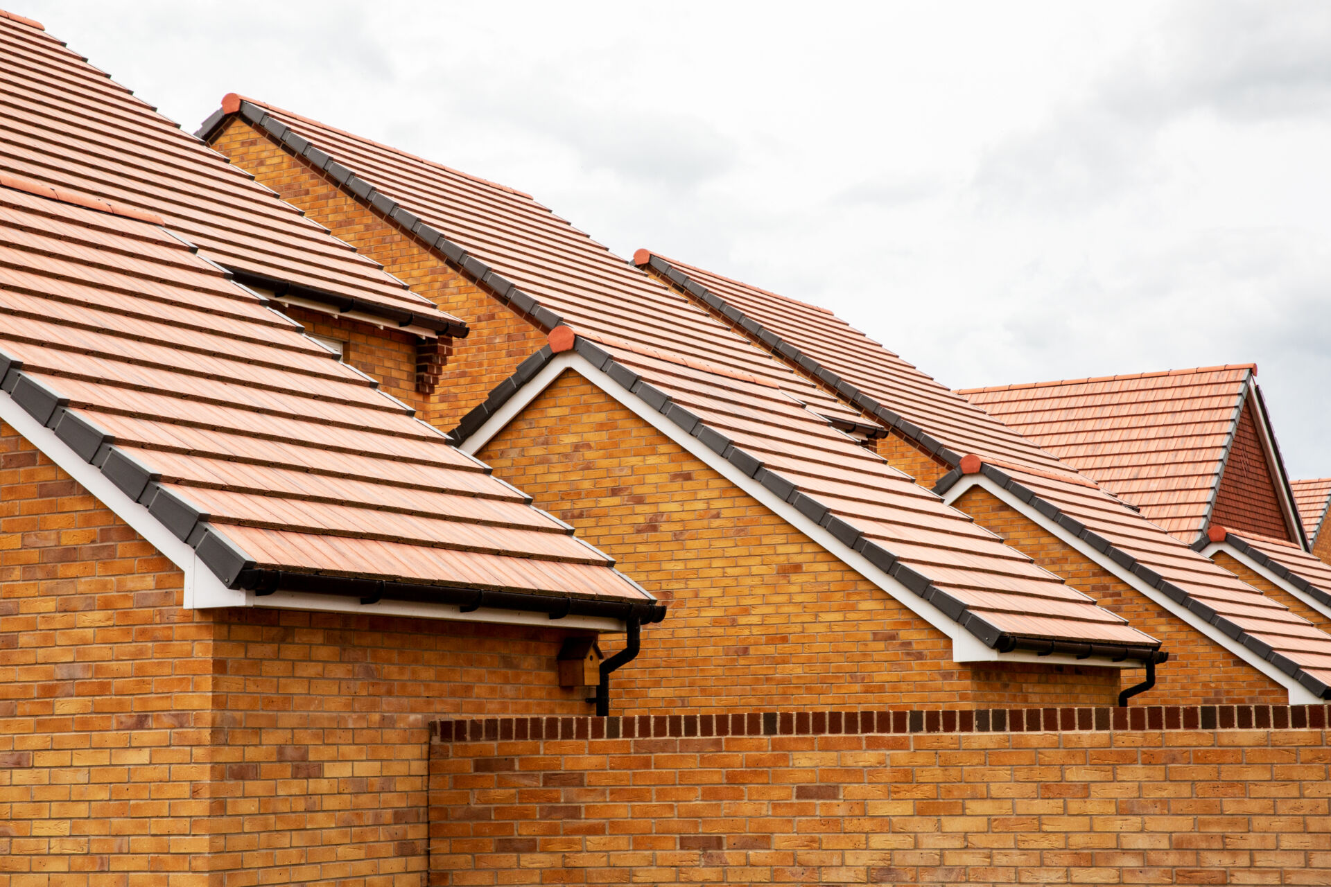Row of houses with long pitched tiled roofs
