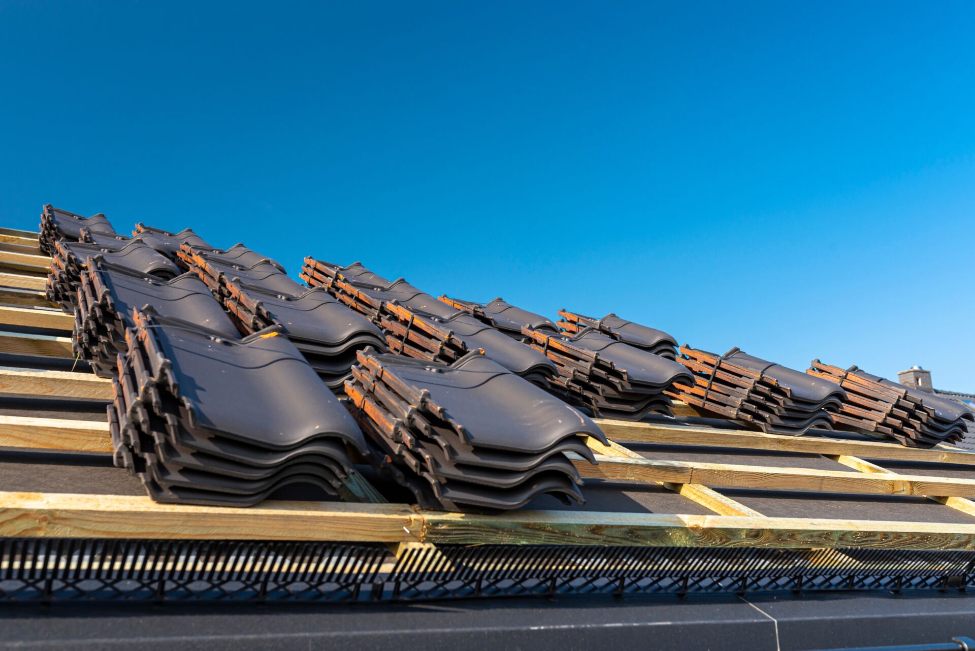Piles of fired ceramic tiles ready to be installed on the roof
