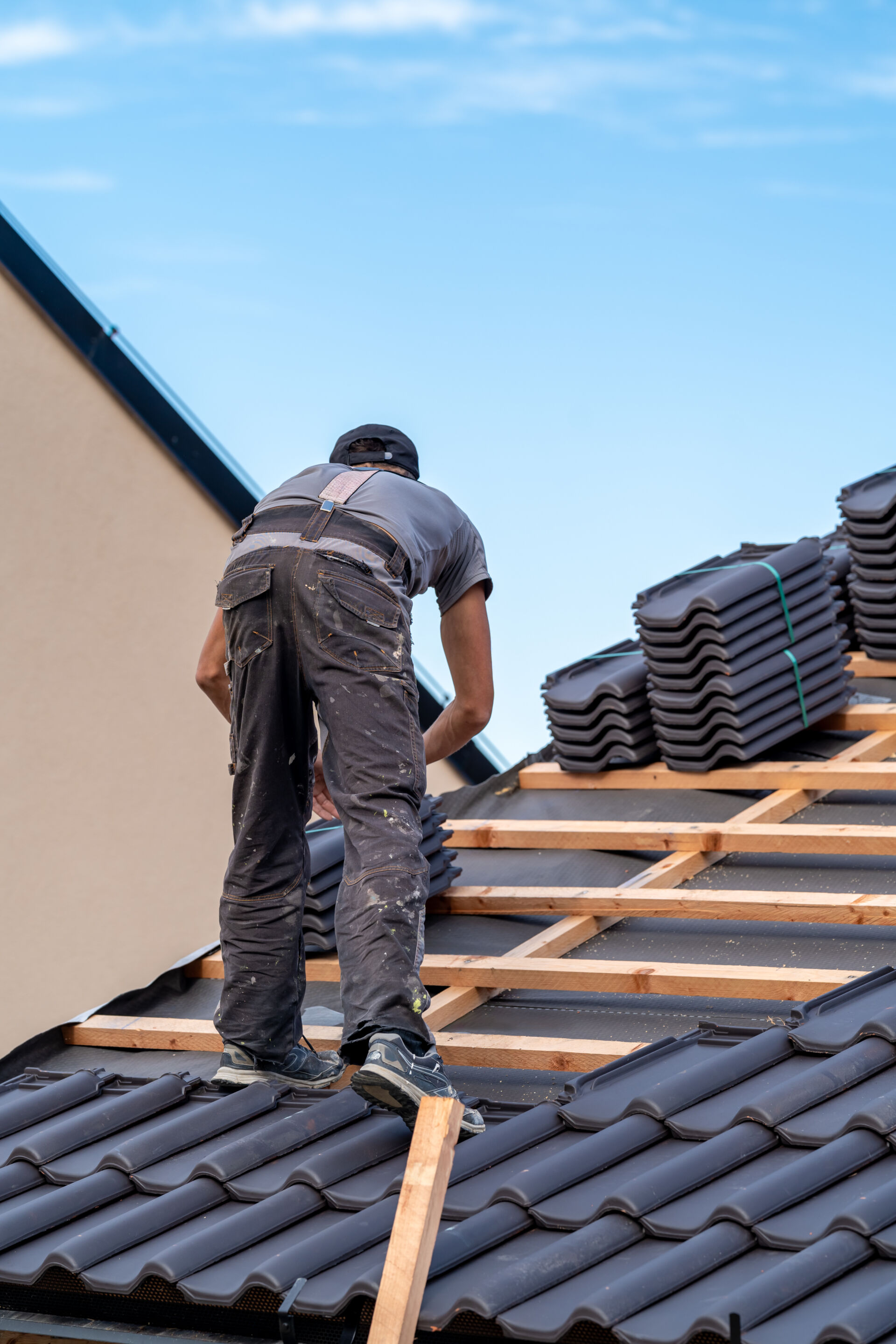 Fired ceramic tiles being installed on the roof