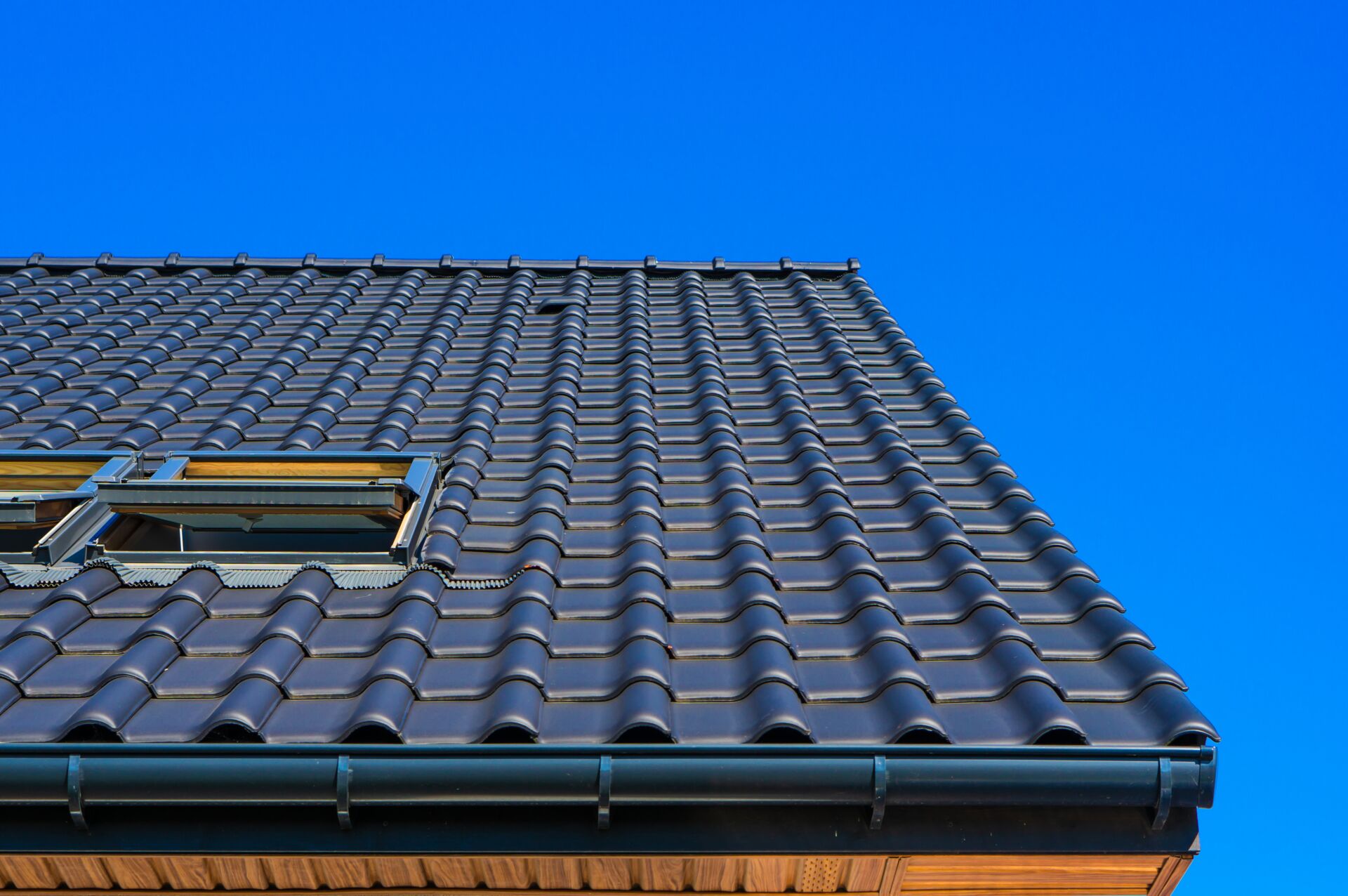 Fired ceramic tiles being installed on the roof